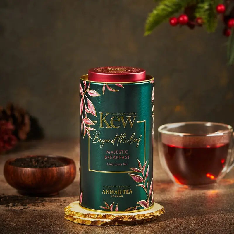Kew Gardens Caddy Majestic Breakfast Tea with loose leaf blend and cup.