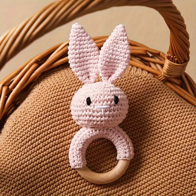 Crochet Rabbit Baby Rattle in pink with wooden handle for newborns.