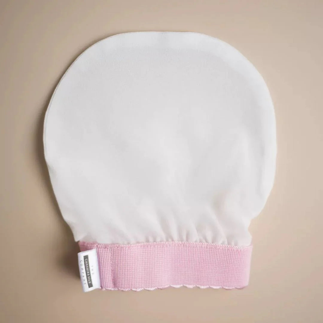 Silk exfoliating mitt for luxurious skin pampering and skincare routine.