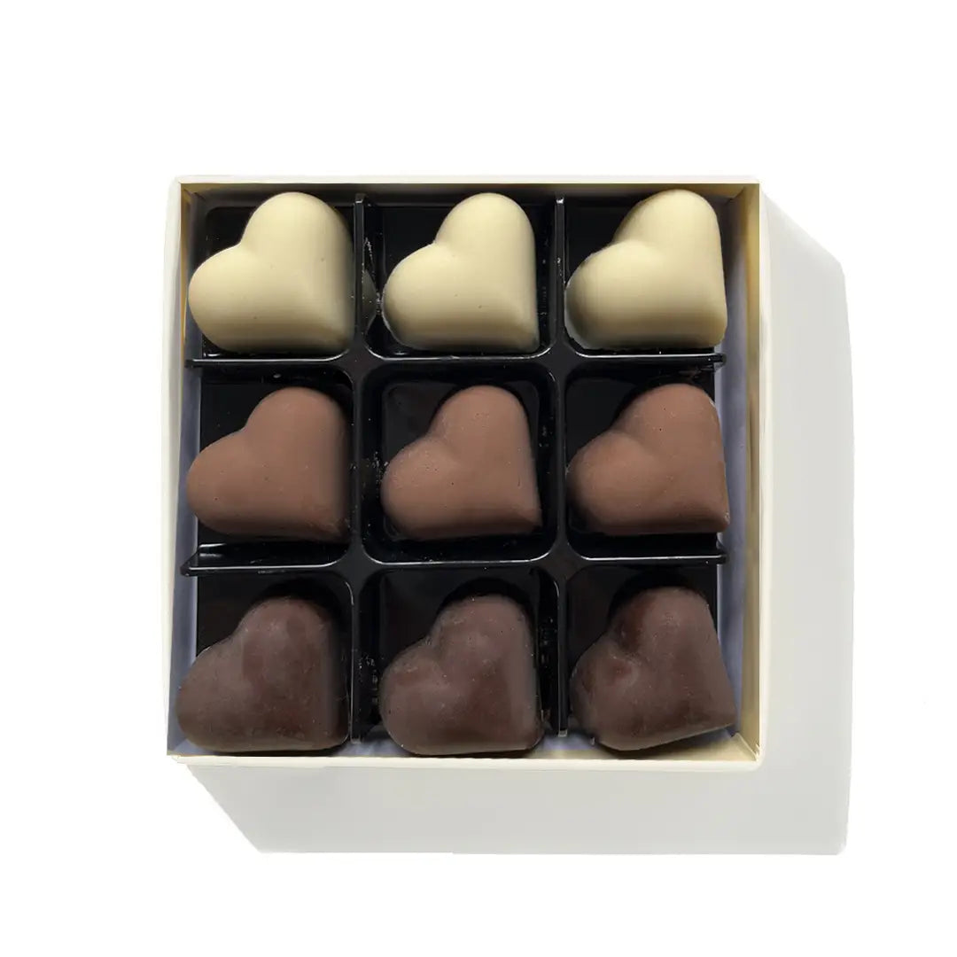 Assorted Belgian chocolate hearts in milk, dark, and white varieties.