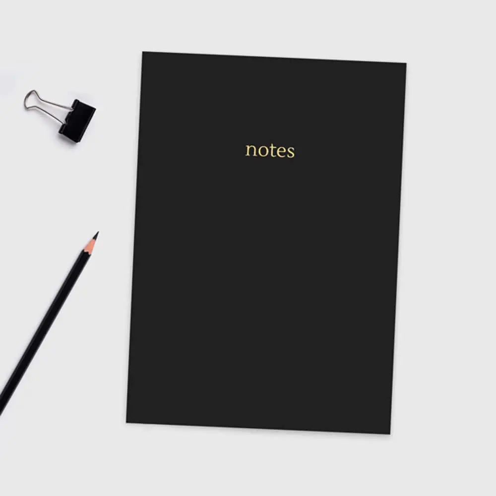Black A5 Colourblock Notebook with gold foil 'notes' lettering, sleek design with colored paper edges.