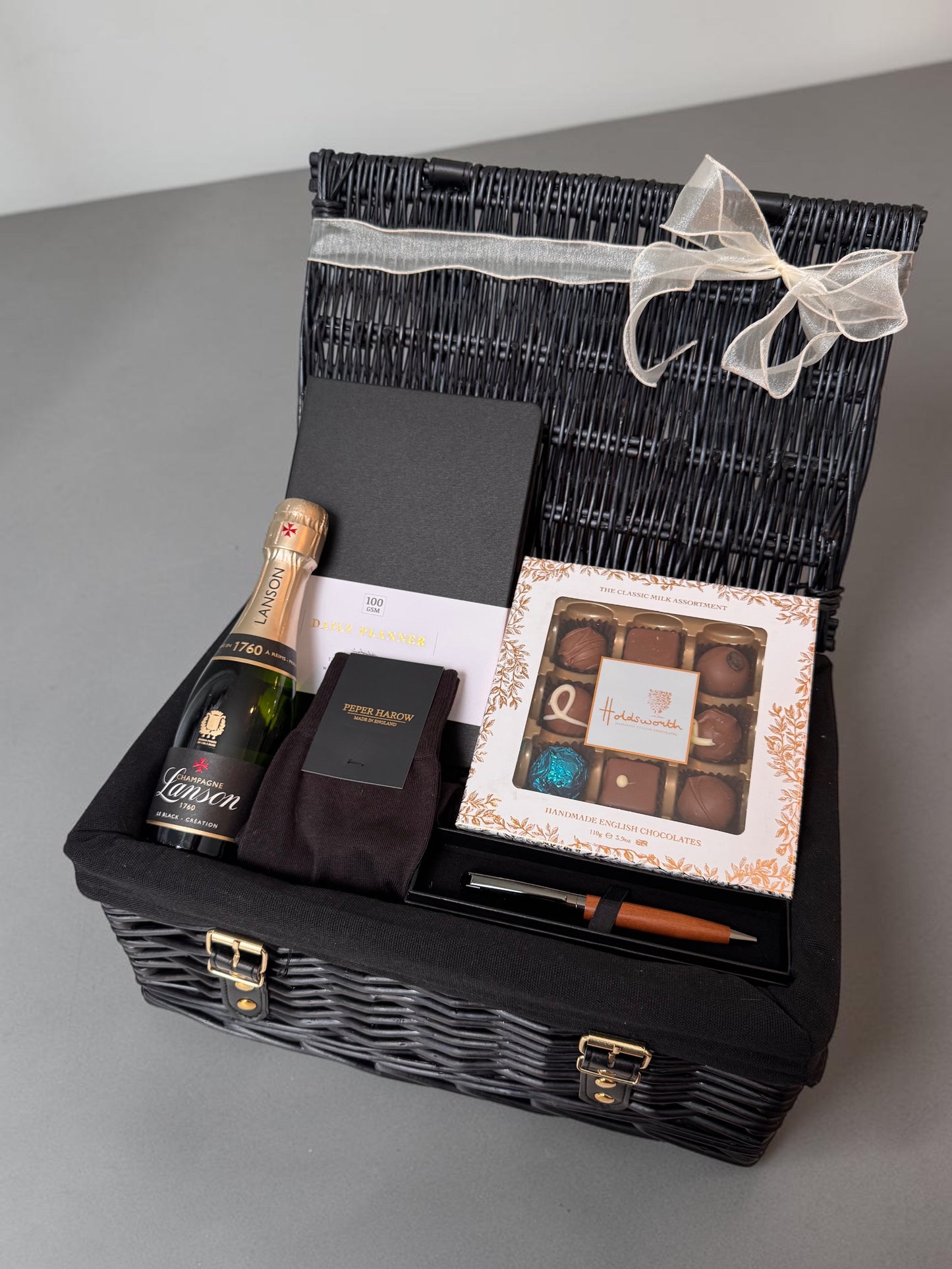 Exam results gift hamper with champagne, socks, planner, pen and chocolates