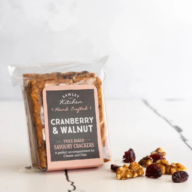 Artisan cranberry and walnut savoury crackers in a clear bag with hand-tied label, perfect for cheese pairings.