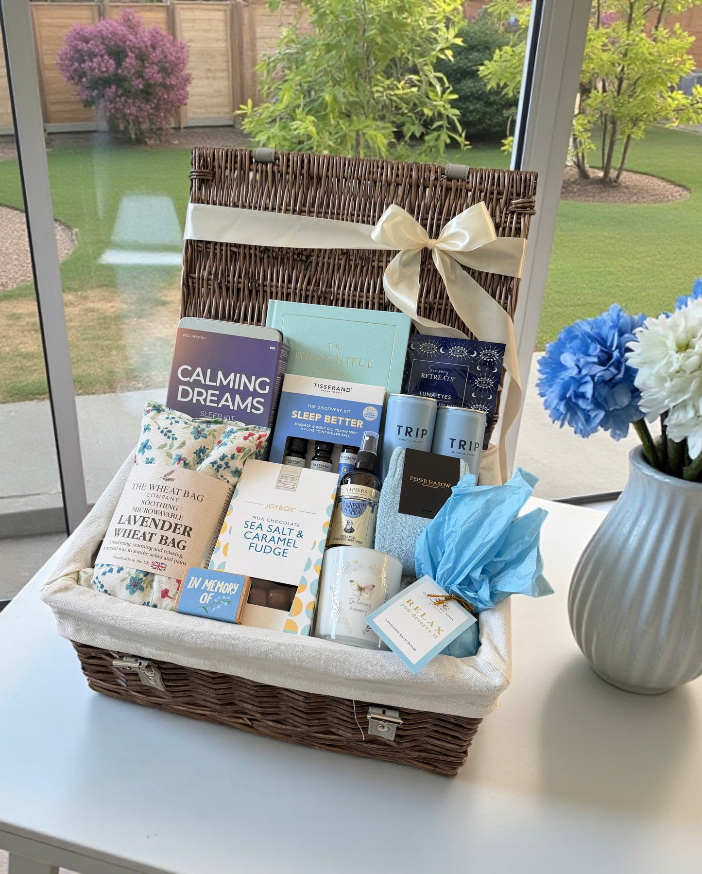 Deep rest and relief bereavement hamper with wheat bag, in loving memory candle and seed bombs, magnesium spray, fudge, house socks and more