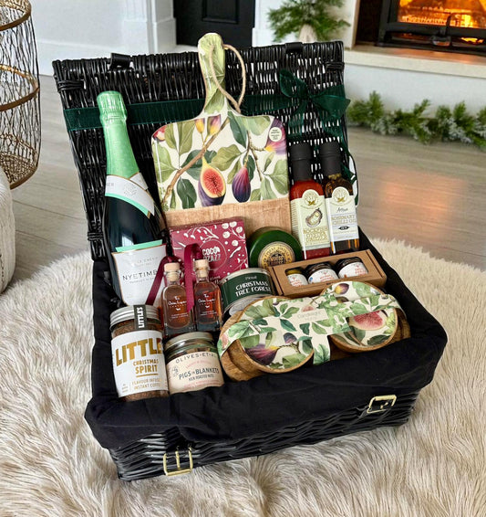 Luxury Fig & Festivities Hamper with sparkling wine, fig accessories, gourmet treats & festive delights in black wicker basket.