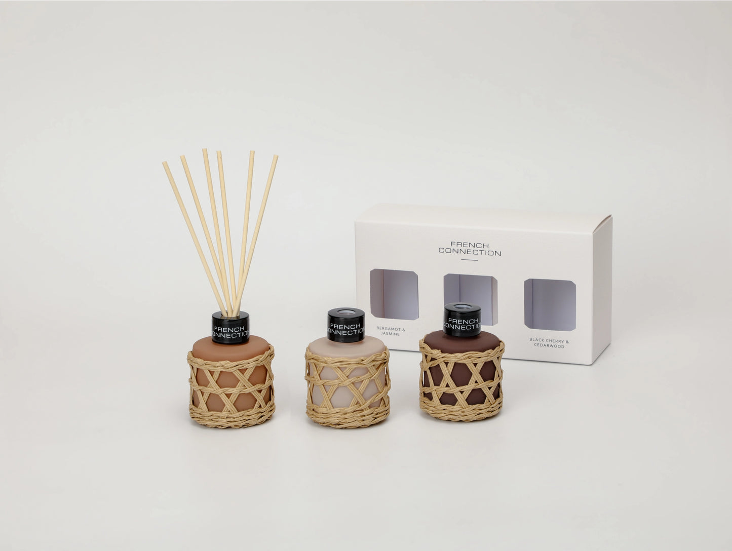 Three diffusers with reeds and a box labeled 'French Collection' on a white background