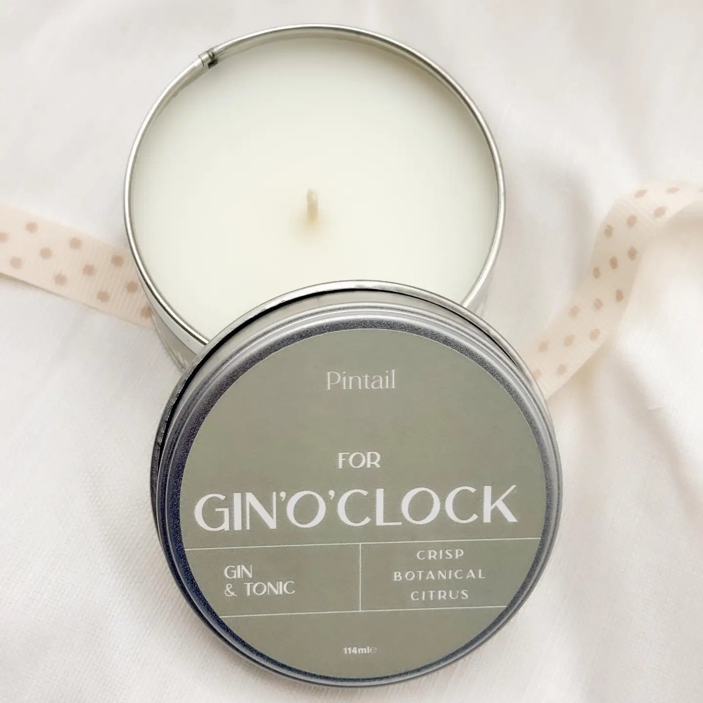 Gin O’Clock Candle in tin with lid displaying crisp botanical citrus scent.