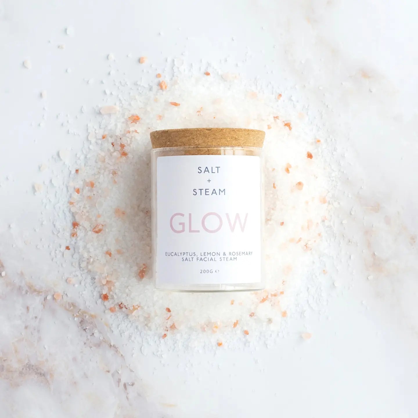 Eucalyptus, Lemon & Rosemary Facial Steam jar on marble background. Vegan friendly.