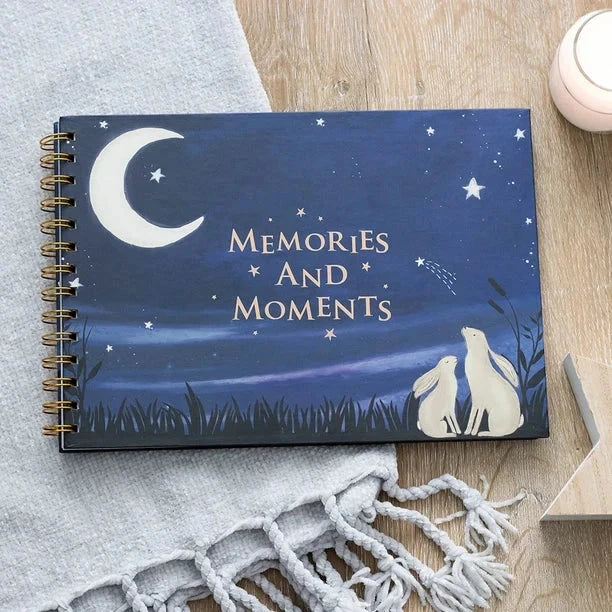 Baby Book titled "Memories and Moments" with night sky design, ideal for capturing milestones.