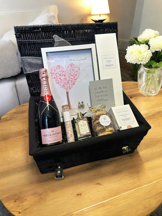 Love & Celebration Hamper with Moët & Chandon Rosé, Moroccan Rose Diffuser, bath soak, chocolate biscuits, and framed artwork for special occasions.