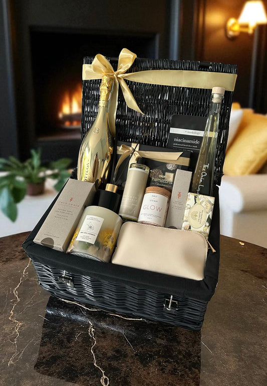 Luxury Pamper Hamper with Bottega Gold Prosecco, Oxton Rhubarb Vodka, True Grace lotion, niacinamide mask, Hamiltons chocolates, candle, diffuser, and facial steamer.