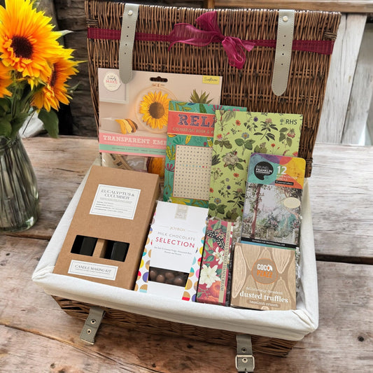 Craft Lover gift box with embroidery kit, coloring book, sketchbook, pencils, truffles, hand cream, chocolates, and candle making kit.