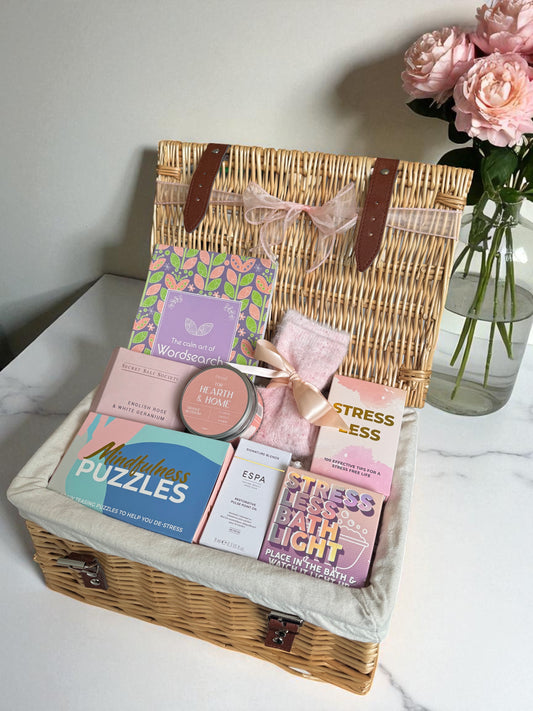 Stress Less Calming Gift Box including mindfulness puzzles, fluffy socks, bath salts, bath oil, Heath & Home candle, and ESPA restorative pulse oil.