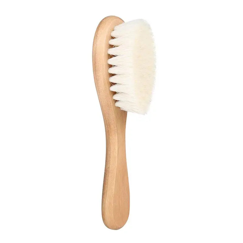 Baby hairbrush with super soft wool bristles and a wooden handle.