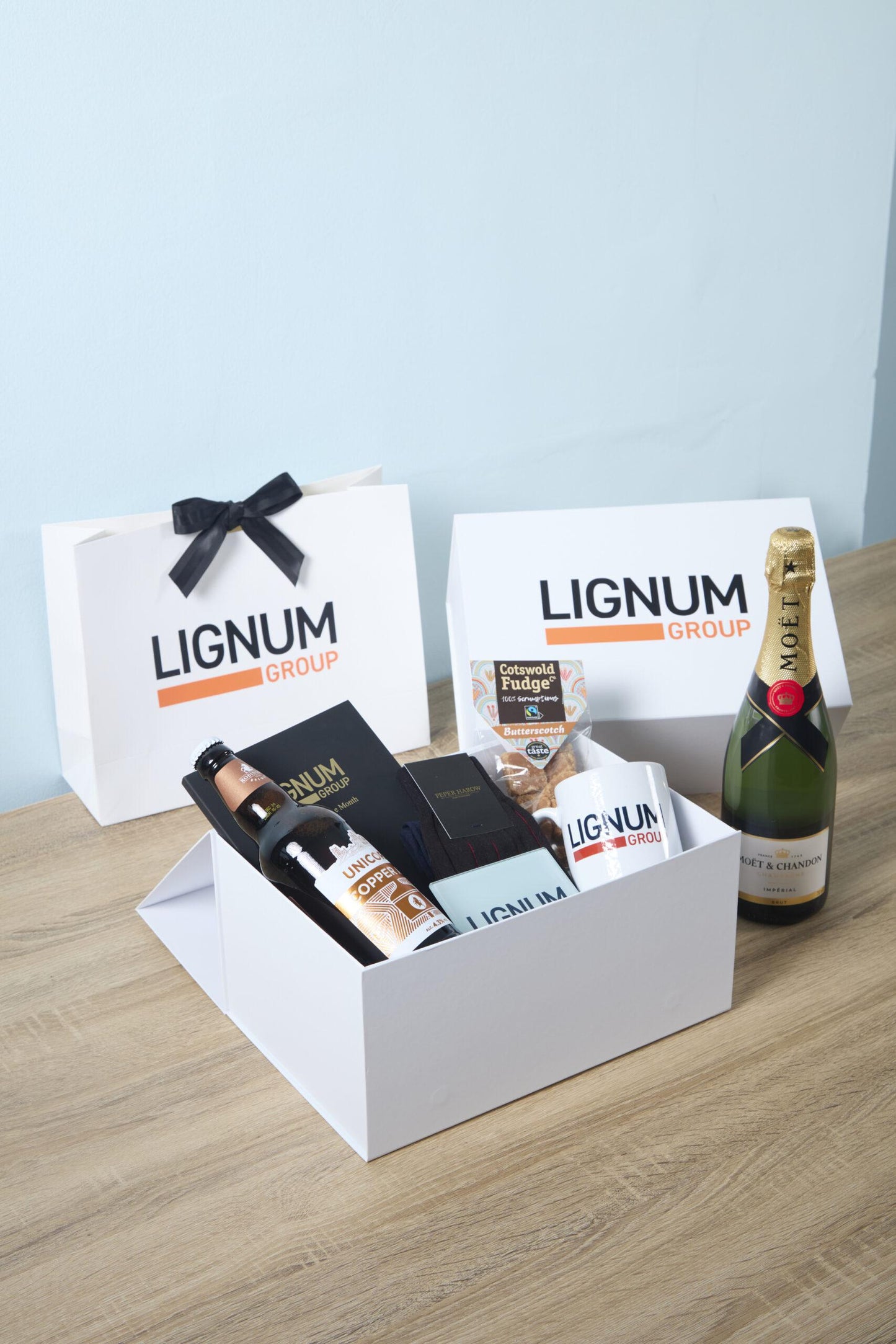 Gift box for client prospecting with branded items and champagne.