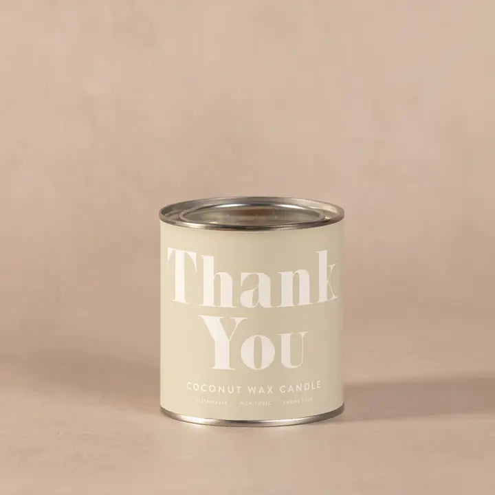 Thank You Conscious Candle in beige tin container.