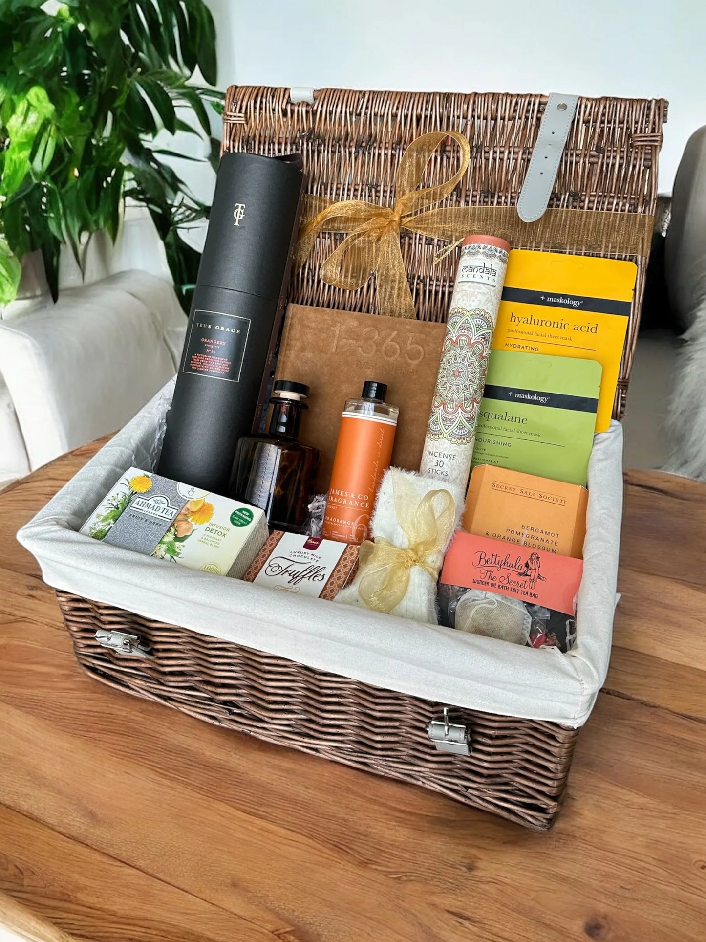 Rest and Reflect Gift Box with journal, socks, diffuser, bath products, face masks, incense, tea, and chocolate truffles.