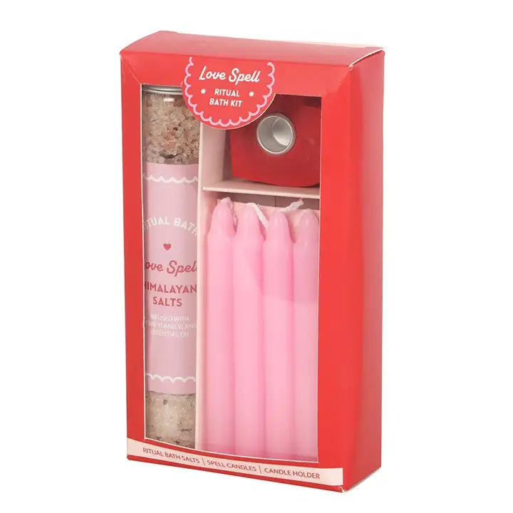 Love Spell Ritual Bath Kit with Himalayan bath salts, pink spell candles, and heart-shaped candle holder.