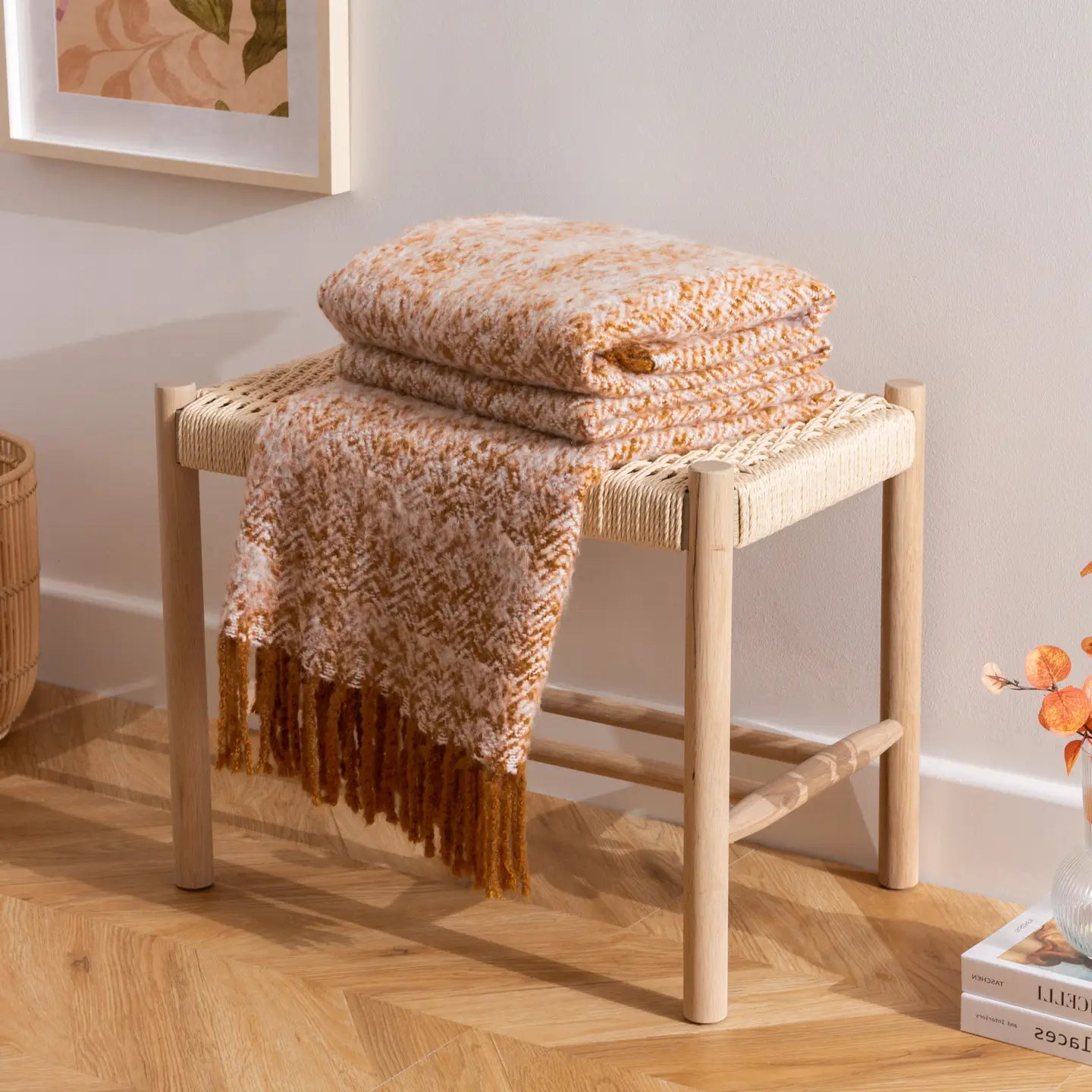 Herringbone print throw with soft textured finish, earth-toned colourways, and 10cm tassel trim — a cosy, versatile home accessory.