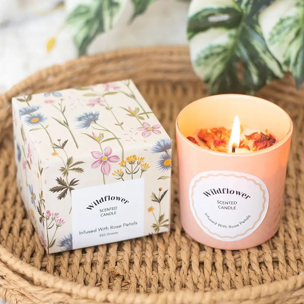 Wildflower candle in pink glass with rose petals, boxed for gifting.