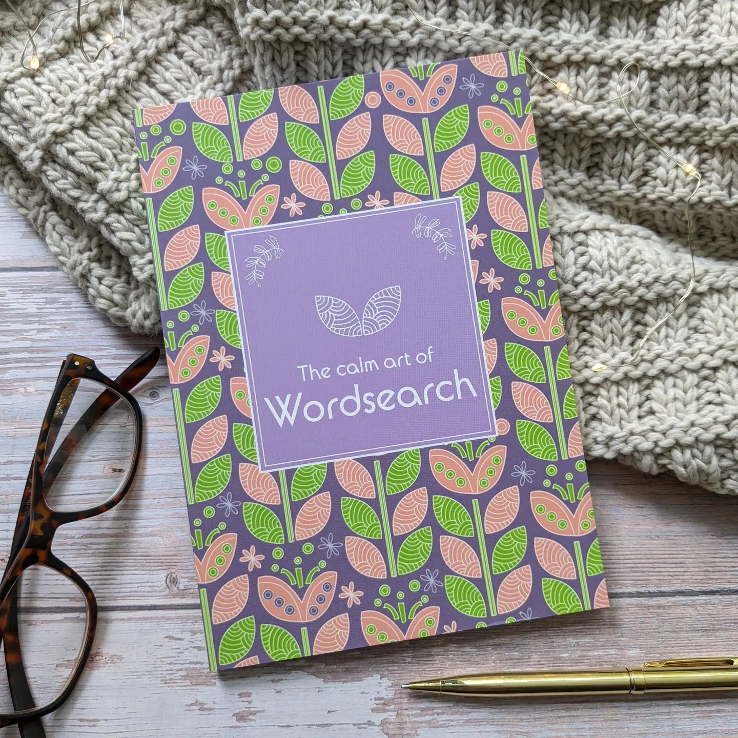 Wordsearch book for grown-ups with a calming purple cover and floral design, ideal for relaxation.