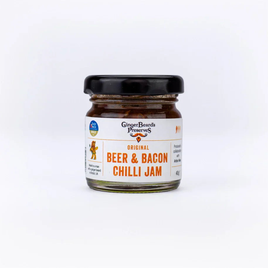 Miniature jar of Beer & Bacon Chilli Jam, perfect for gourmet sandwiches and cheese platters.