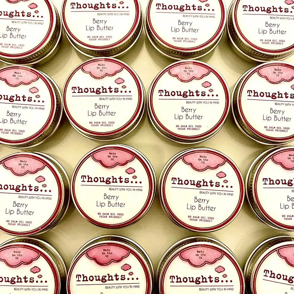 Handmade vegan berry lip butter tins arranged neatly.
