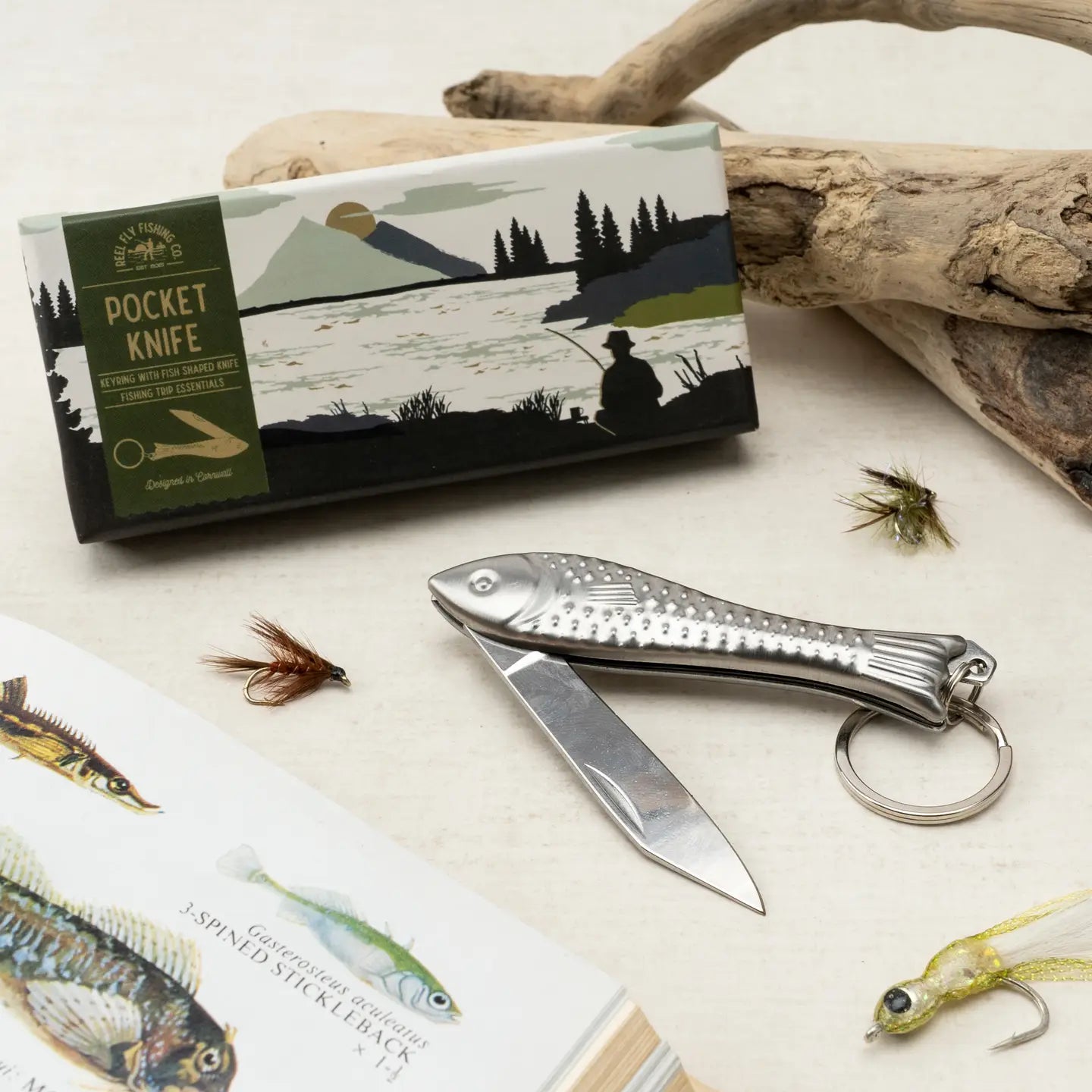 Reel Fly Fishing Co. fish-shaped pocket knife with whimsical design and packaging.