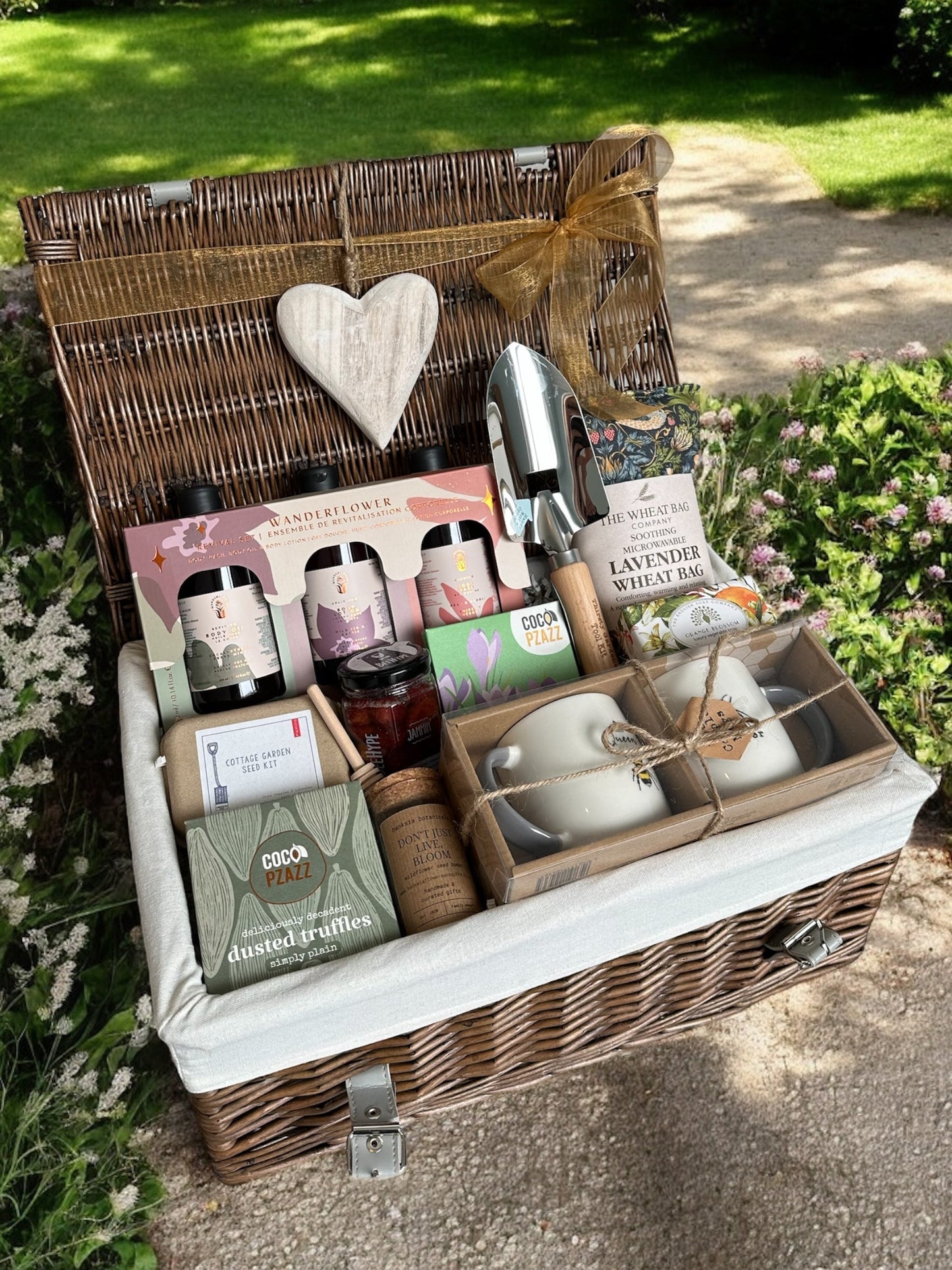 Grandparents Garden Delight hamper with sweet treats, mugs, wildflower seeds, lavender wheat bag, and self-care items.