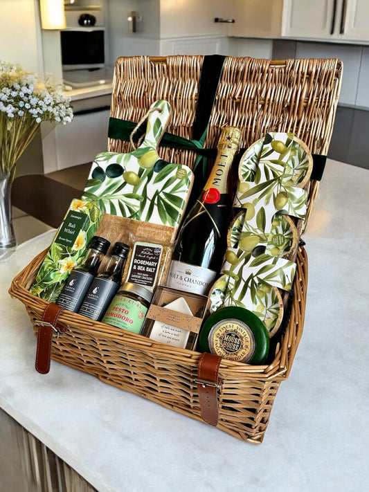 New Home Celebrations hamper with Moët Champagne, serving board, dipping bowls, ring dish, sun-dried tomato pesto, Bali Whirl room spray, vintage cheddar, crackers, strawberry and mint balsamic, rhubarb and ginger balsamic.