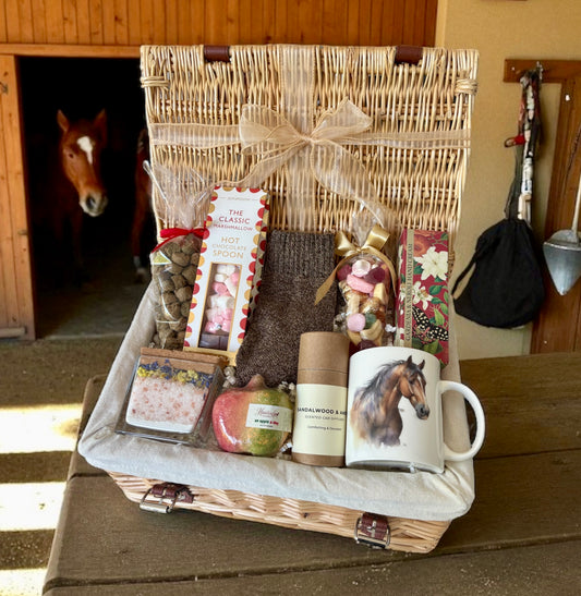 Gift basket with horse-themed items in a stable setting