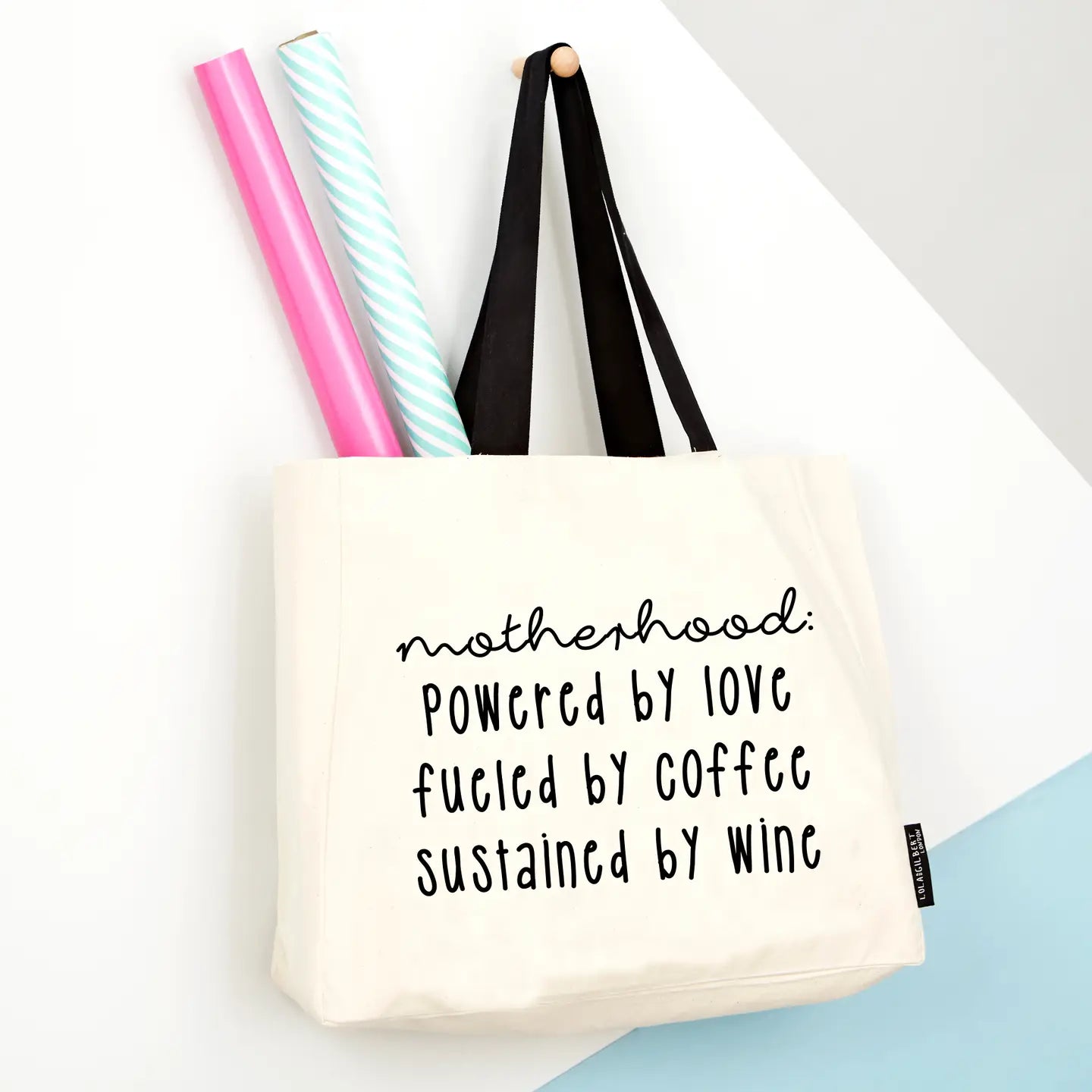Humorous 'Motherhood, Powered By Wine' large tote bag with thick canvas and strong handles.