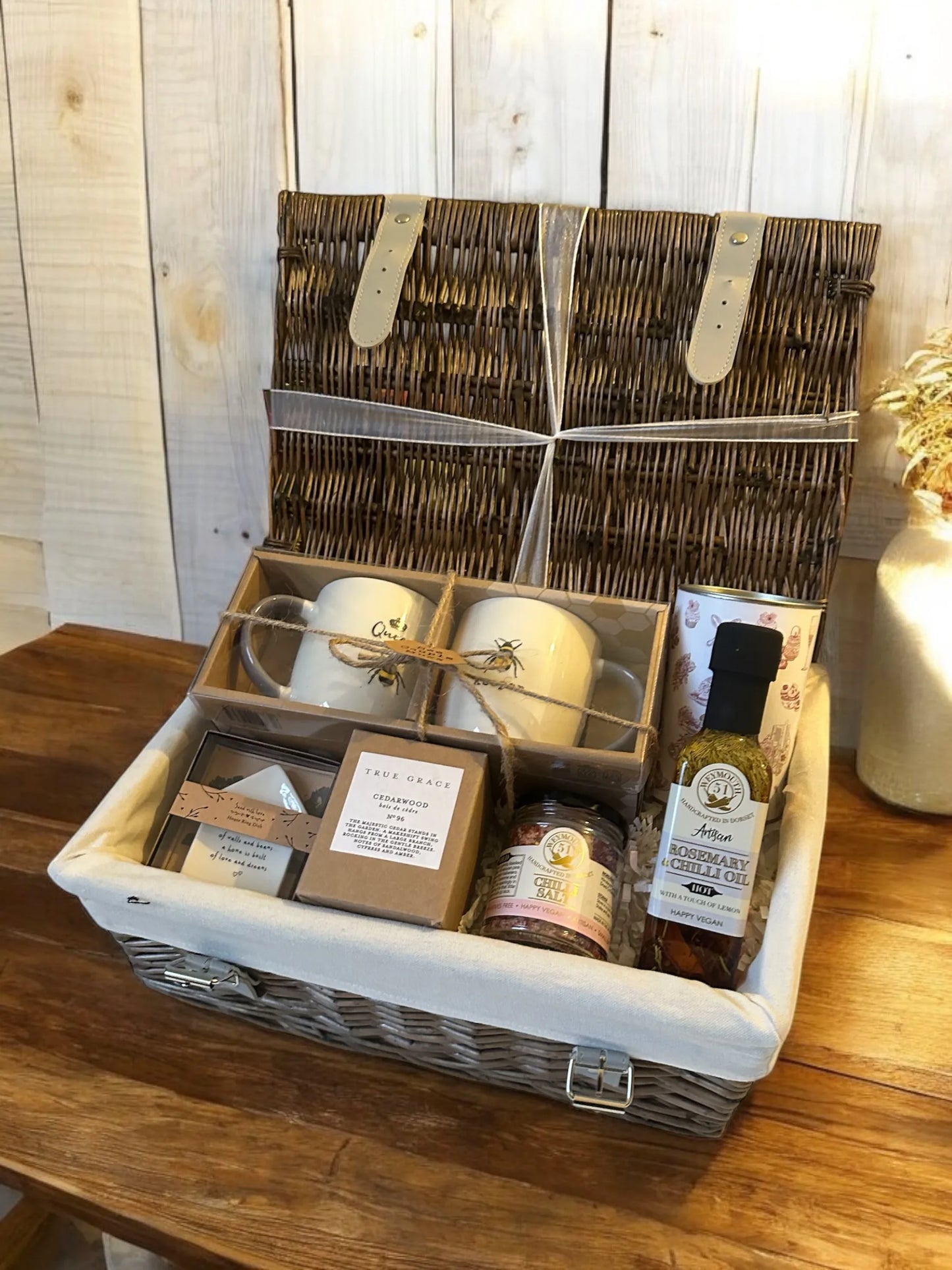 Homely Treats Hamper with mugs, Wild Lime candle, English breakfast tea, and gourmet oils.