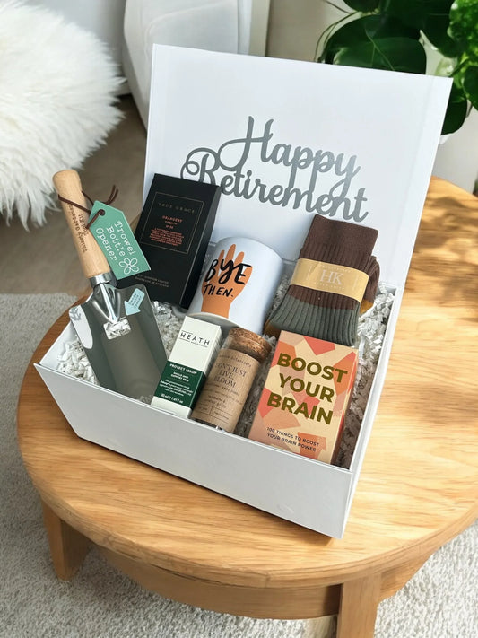Bye Then Retirement Box with various gifts on a table, designed for happy retirement celebrations.
