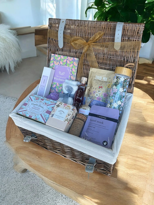 Female retirement gift basket with tea and assorted treats.