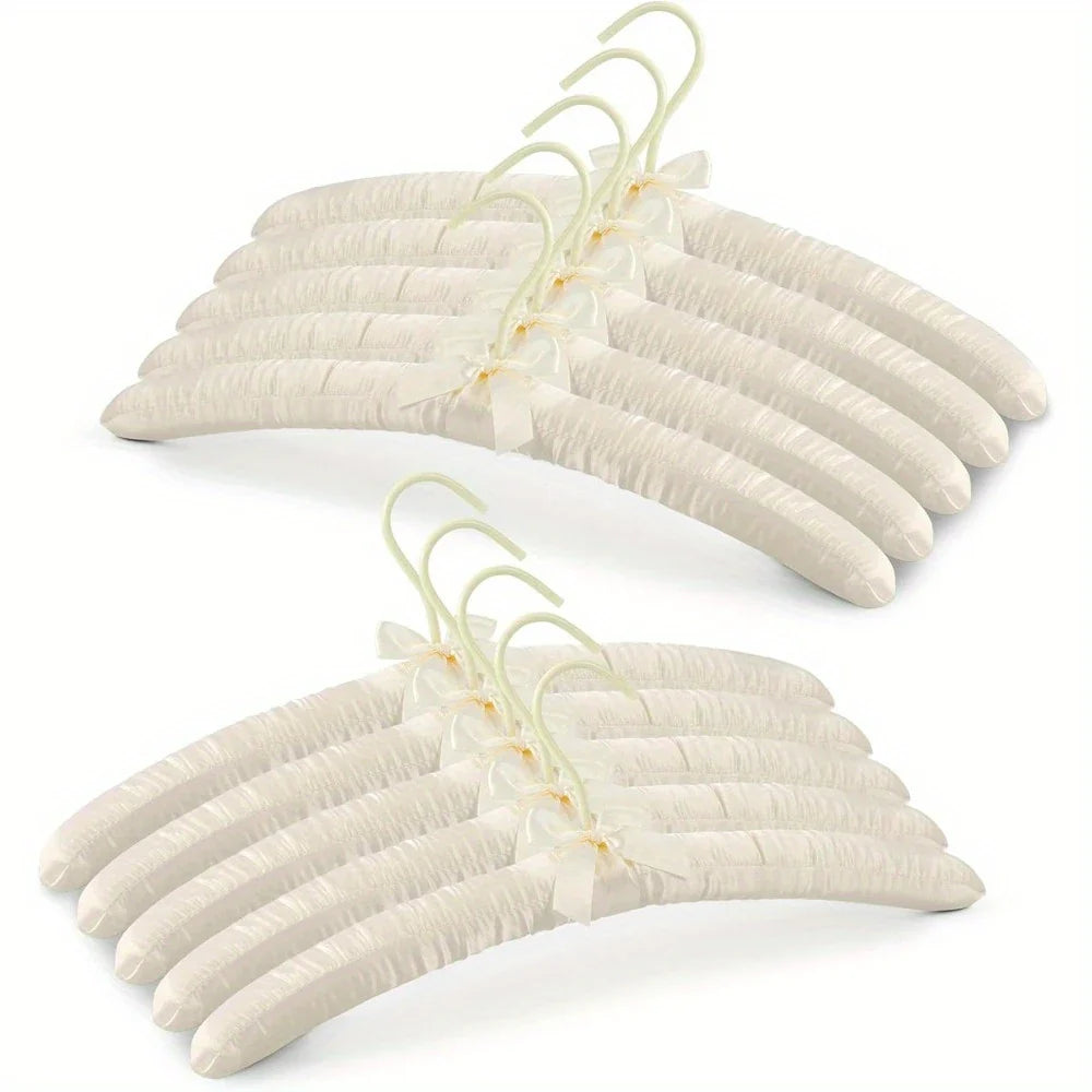 Luxury satin coat hangers in pale cream, ideal for bridal parties or adding elegance to wardrobes.