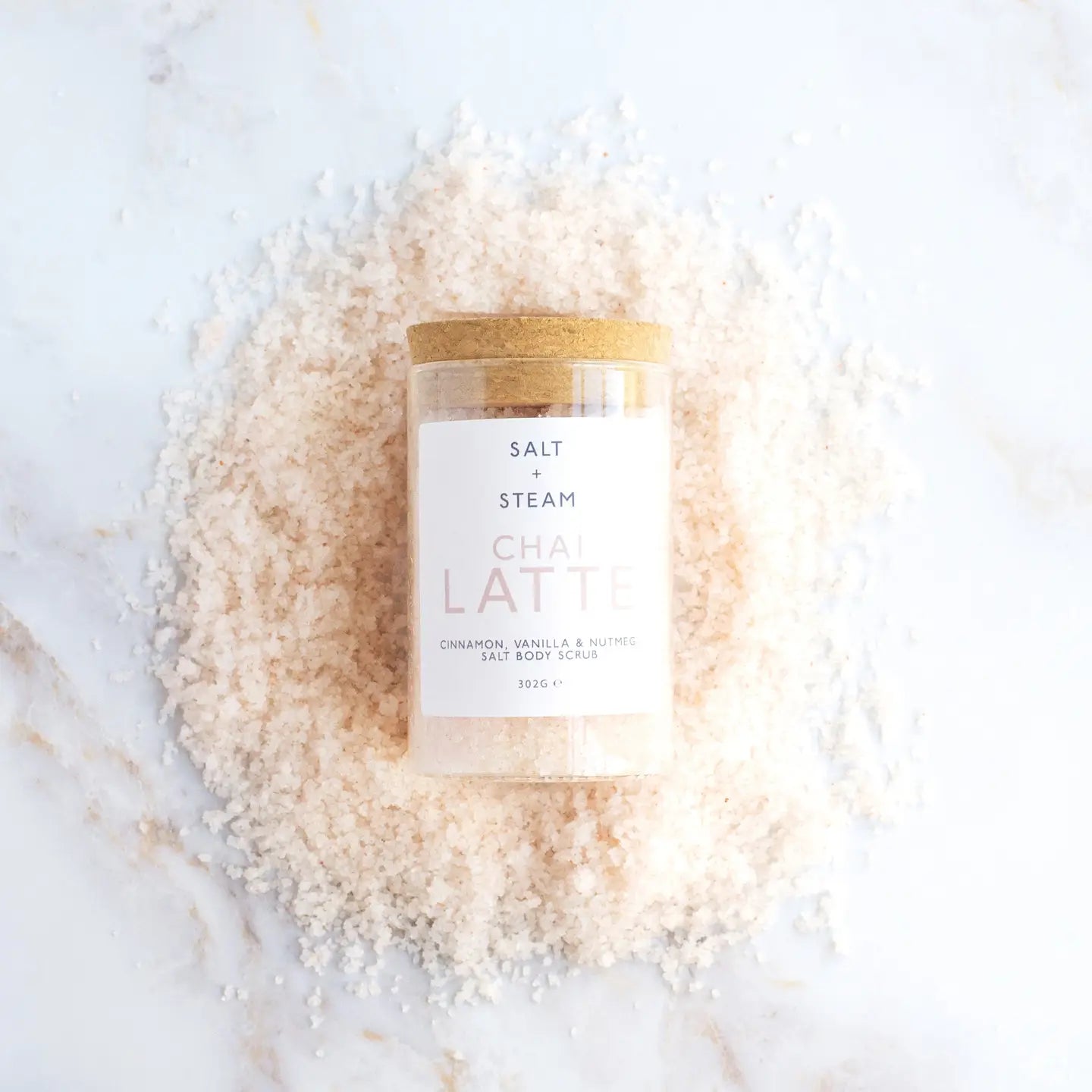 Spiced Vanilla Body Scrub in jar on white background.