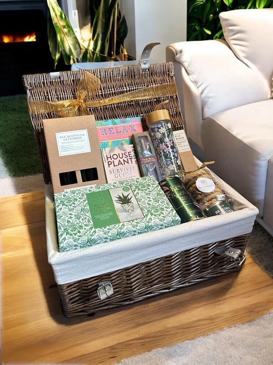 Ultimate Crafty Hamper displayed in a wicker basket on a wooden table, featuring various craft and relaxation items.