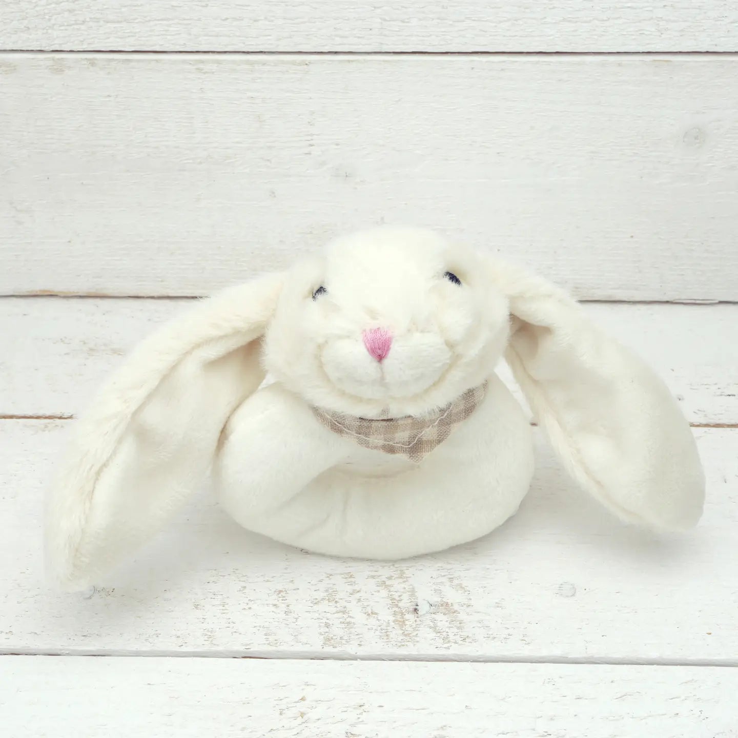 Cream-colored baby bunny toy rattle with long ears.