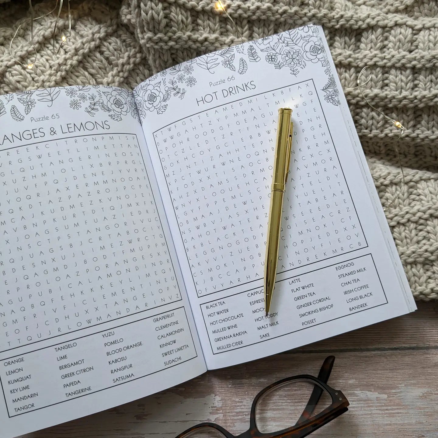 Wordsearch Book for Grown-Ups with floral design, featuring open pages on a cozy blanket.
