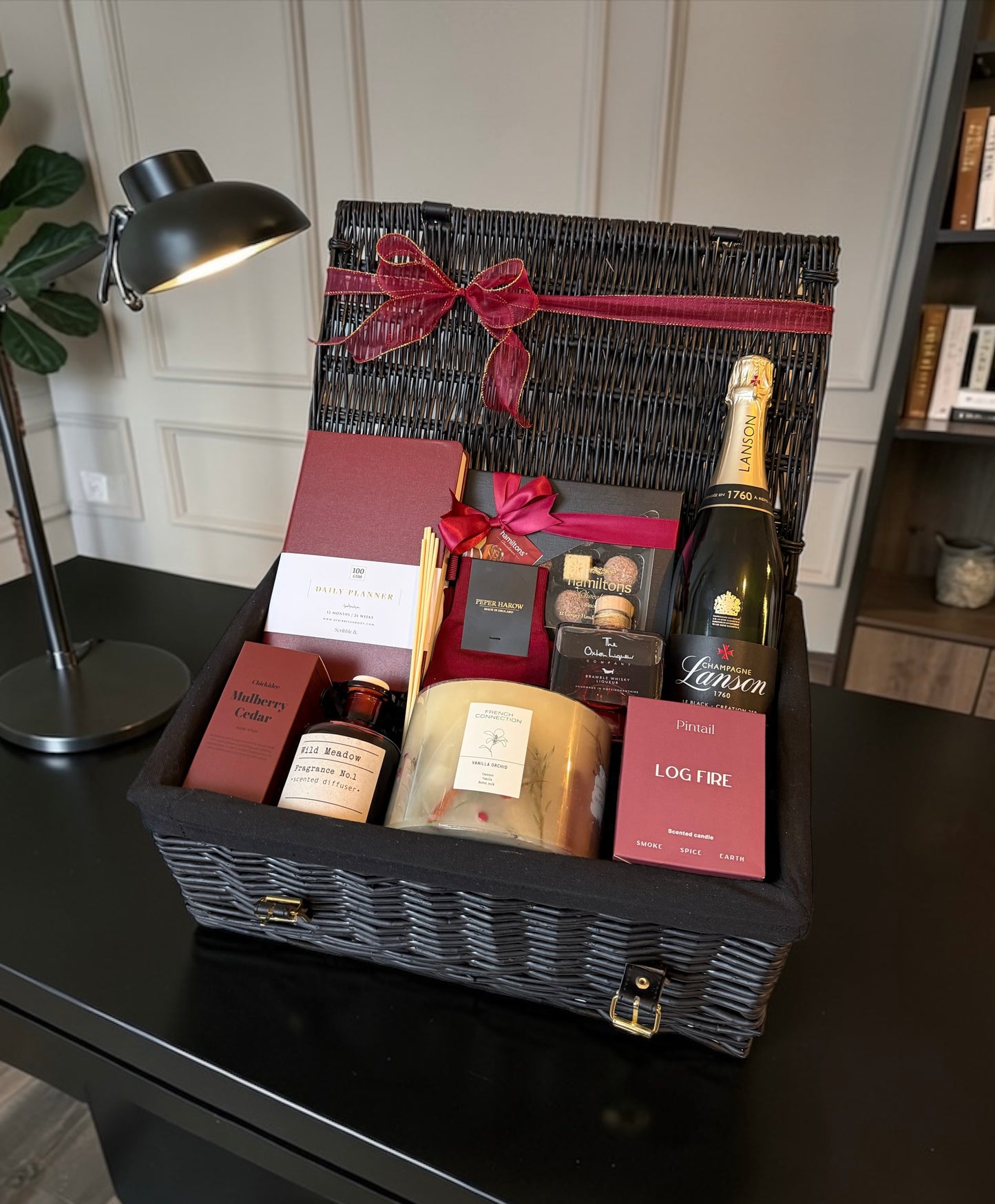 Luxury gift hamper with productivity planner, candles, reed diffuser, chocolates, whiskey and choice of fine wine or Champagne.