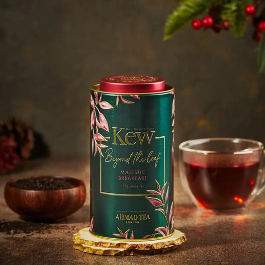 Kew Gardens Caddy Majestic Breakfast Tea with loose leaf blend and cup.