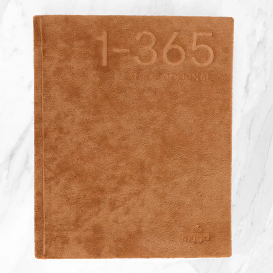 365 Days Journal with brown cover placed on marble background.