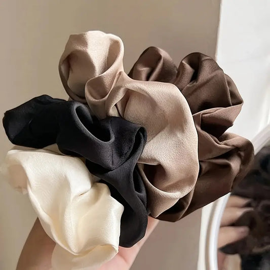 Soft Hair Scrunchies in brown, white, and black.