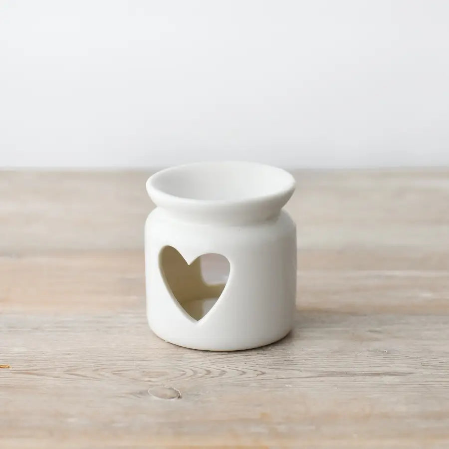 White heart oil burner with cut-out design for fragrance oils and wax melts.