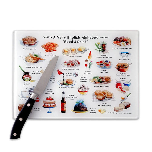 A Very English Alphabet 'Food & Drink' glass cutting board with colorful English cuisine illustrations.