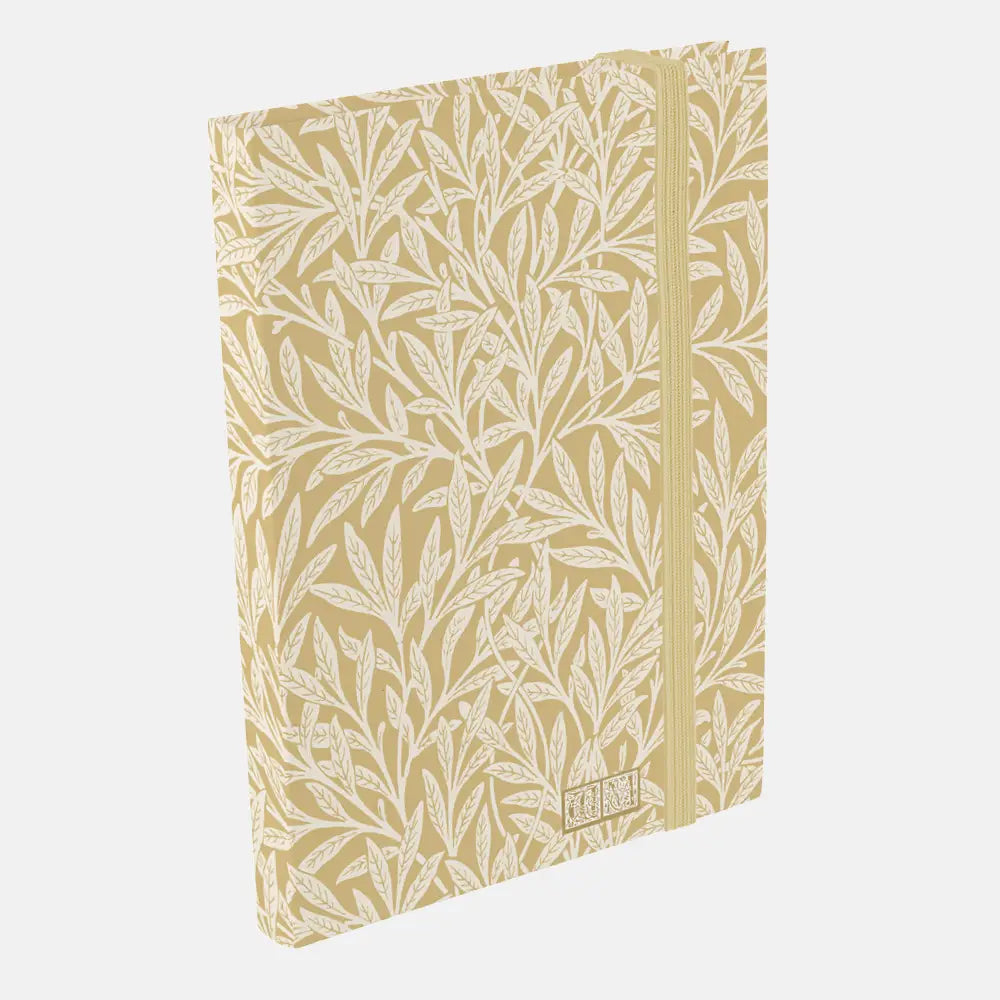 Notebook with leaf pattern on beige cover against a white background