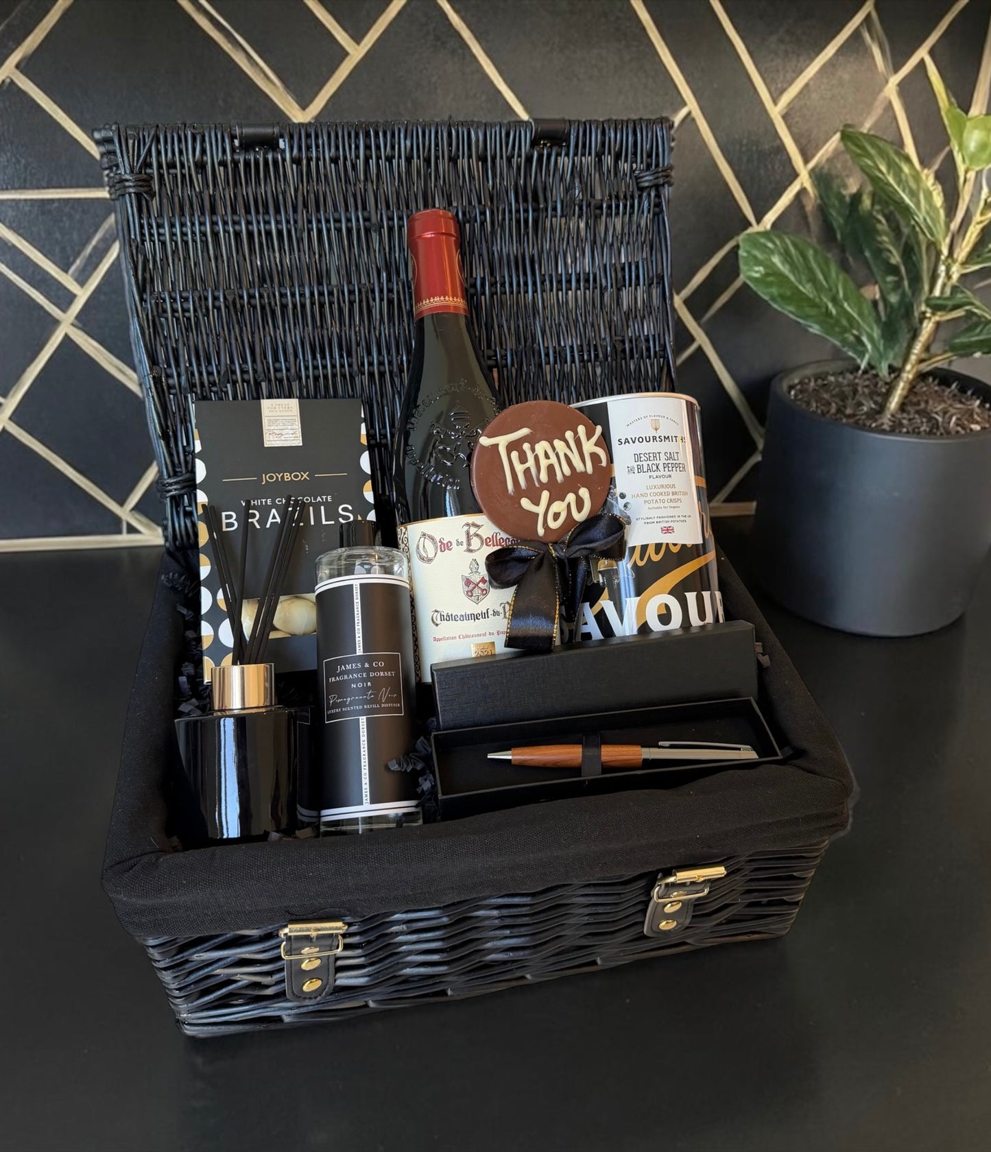 Luxury thank you hamper with chocolates, crisps, diffuser, pen set and red wine.