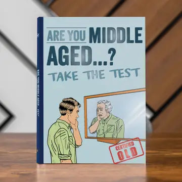 Novelty book "Are You Middle Aged Yet?" with humorous cover illustration, sitting on a wooden surface.