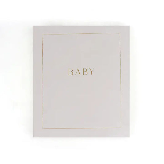 Baby planner journal with gold text on a minimalistic cover.